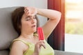 Woman suffering a heat stroke refreshing with a ice cream Royalty Free Stock Photo