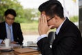 Stressed headache businessman sit near manager