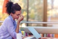 Stressed hipster businesswoman working on laptop in her office Royalty Free Stock Photo