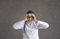 Stressed hospital nurse or doctor bursts into tears isolated on a grey background Royalty Free Stock Photo