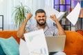 Stressed Indian man looking at unpaid bank debt loan, doing paperwork, planning budget, throws bills Royalty Free Stock Photo