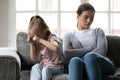 Stressed little school aged girl crying, abused by nanny. Royalty Free Stock Photo