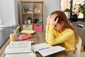 Stressed little student girl learning at home