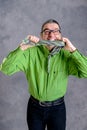 Stressed man in green shirt and glasses biting in his necktie Royalty Free Stock Photo