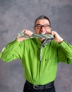 Stressed man in green shirt and glasses biting in his necktie Royalty Free Stock Photo