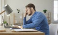 Tired, stressed, frustrated young man having problem while working on his laptop Royalty Free Stock Photo