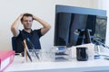 Stressed man at job into office in front of his computer.Office clerk into burn out concept Royalty Free Stock Photo