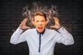 Stressed man screaming with smoke coming out of his ears Royalty Free Stock Photo