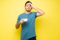 Stressed man suffering from a headache and drinking coffee Royalty Free Stock Photo