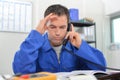 Stressed manual worker on phone Royalty Free Stock Photo