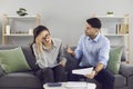 Stressed married millennial couple arguing because of bills expenses at home