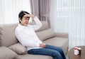 Stressed mature senior woman touching head with closed eyes at sofa in living room Royalty Free Stock Photo
