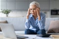 Stressed Mature Woman Touching Head In Despair Calculating Budget Indoors Royalty Free Stock Photo