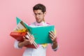 Stressed mid aged man employee holding stack Royalty Free Stock Photo