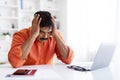 Stressed middle aged indian businessman sitting at desk with laptop Royalty Free Stock Photo