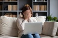 Stressed middle aged woman hiding face with both hands.