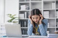 Stressed millennial Asian businesswoman or female manager having a serious use laptop with her business client while Royalty Free Stock Photo