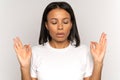 Stressed african woman holding hands in yoga gesture manage stress breathing deeply with closed eyes