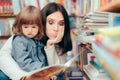 Stressed Mom Checking an Awkward Book for Kids in a Library