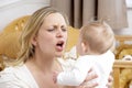 Stressed Mother Holding Baby In Nursery Royalty Free Stock Photo