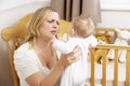 Stressed Mother Holding Baby In Nursery Royalty Free Stock Photo