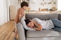 Stressed mother lying on sofa desperate of stubborn kid son, annoyed mom tired of child misbehave Royalty Free Stock Photo