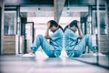 Stressed nurse sitting on floor Royalty Free Stock Photo