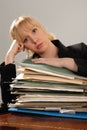 Stressed office executive with stack of paperwork Royalty Free Stock Photo