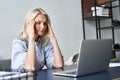 Stressed old business woman suffering from headache after computer work. Royalty Free Stock Photo