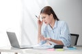 Stressed out Asian Business woman using calculator and laptop for doing math finance on an office desk, tax, report Royalty Free Stock Photo