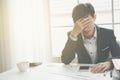 A stressed out business man holds his head in despair Royalty Free Stock Photo