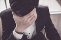 A stressed out business man holds his head Royalty Free Stock Photo