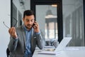 Stressed out businessman in office making important phone call about serious problem working under pressure and tight deadline Royalty Free Stock Photo