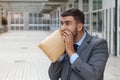 Stressed out man breathing through paper bag Royalty Free Stock Photo