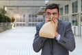 Stressed out man breathing through paper bag Royalty Free Stock Photo