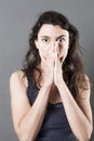 Stressed out woman hiding her mouth for mistake or consternation