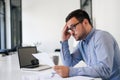 Stressed out and worried overworked businessman in office working under pressure and tight deadline Royalty Free Stock Photo