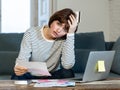 Stressed and overwhelmed young woman paying credit card debts and bills on laptop Royalty Free Stock Photo