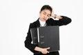 Stressed overworked and confused young Asian business woman in suit troubled with financial problem over white isolated background Royalty Free Stock Photo
