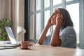 Stressed overworked old mature business woman suffering from headache at work. Royalty Free Stock Photo