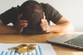 Stressed person covering his face after bitcoin investment is failure and he was bankrupt