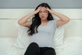 Stressed pregnant woman suffering headache lying in bed Royalty Free Stock Photo