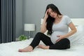 Stressed pregnant woman suffering headache lying in bed Royalty Free Stock Photo