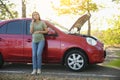 Stressed pregnant woman talking on phone near broken car outdoors Royalty Free Stock Photo