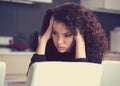 Stressed sad young housewife sitting in modern kitchen Royalty Free Stock Photo