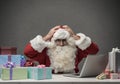 Stressed Santa connecting with his laptop Royalty Free Stock Photo