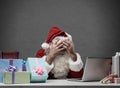 Stressed Santa connecting with his laptop Royalty Free Stock Photo