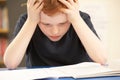 Stressed Schoolboy Studying In Classroom Royalty Free Stock Photo