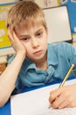 Stressed Schoolboy Studying In Classroom Royalty Free Stock Photo