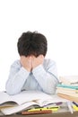 Stressed schoolboy studying in classroom Royalty Free Stock Photo